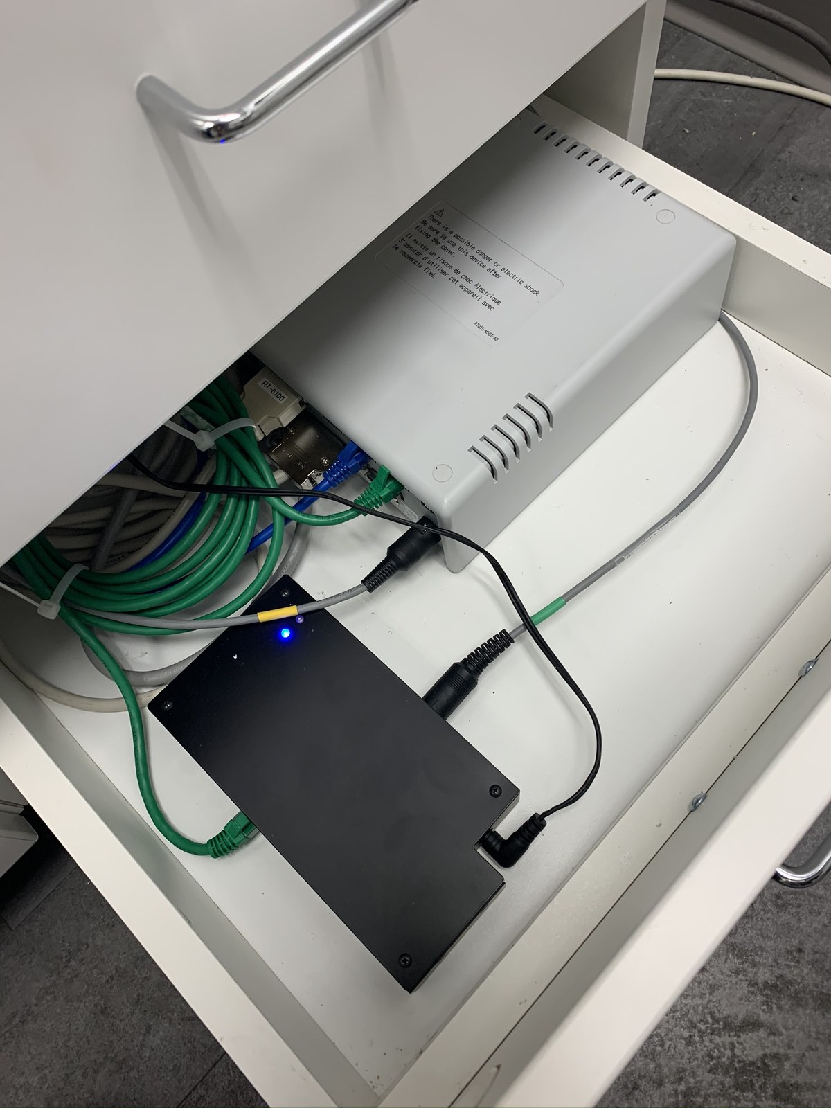 Example drawer-mounted MEM-200 with relay box and cabling installed neatly in a cabinet